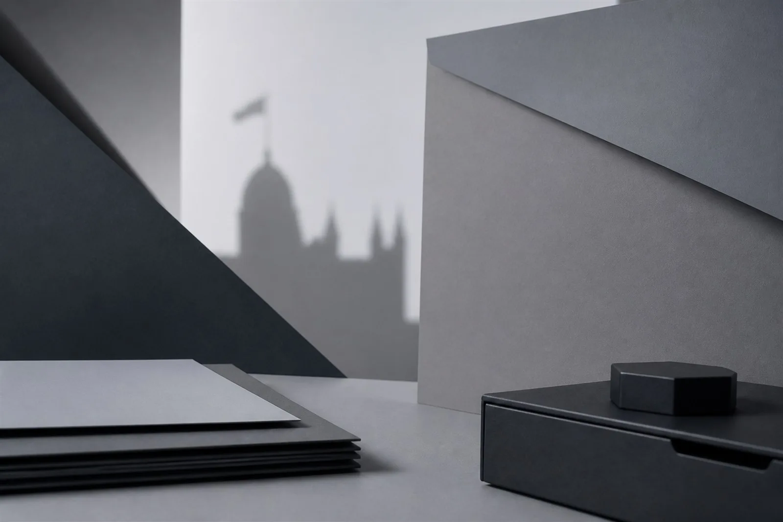 Abstract charcoal and grey forms suggesting UK AI governance research